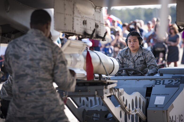 Airmen from the 23d Maintenance Group perform a weapons load demonstration in front of a crowd of spectators, during Thunder Over South Georgia, Oct. 28, 2017, at Moody Air Force Base, Ga. In addition to aerial events, the air show also provided a unique opportunity to educate the public on past and present Air Force capabilities, increase recruiting and show appreciation to the local community. (U.S. Air Force photo by Andrea Jenkins)