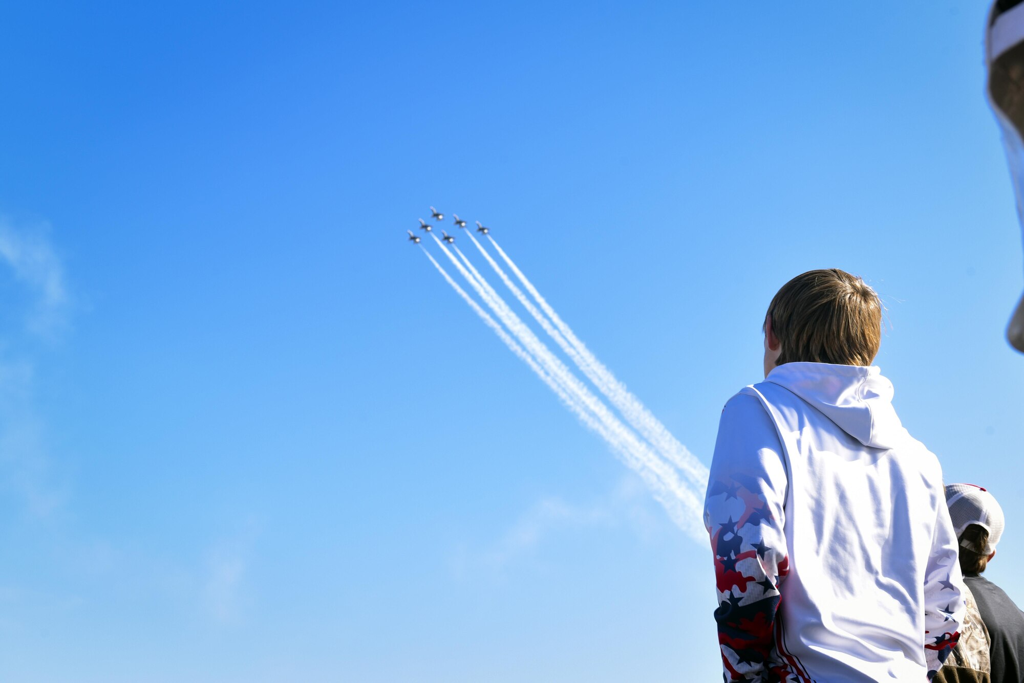 A spectator looks in awe at a performance executed by The U.S. Air Force Thunderbirds Flight Demonstration Team, Oct. 29, 2017, at Moody Air Force Base, Ga. Moody opened its gates to the public for a free, two-day event as a way to thank the local community for their ongoing support of the base’s mission. (U.S. Air Force photo by Senior Airman Greg Nash)
