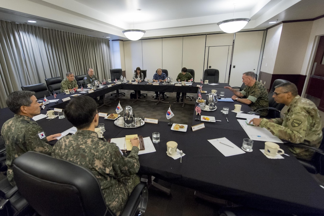 Military leaders conduct a meeting to discuss North Korea.