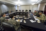 Military leaders conduct a meeting to discuss North Korea.