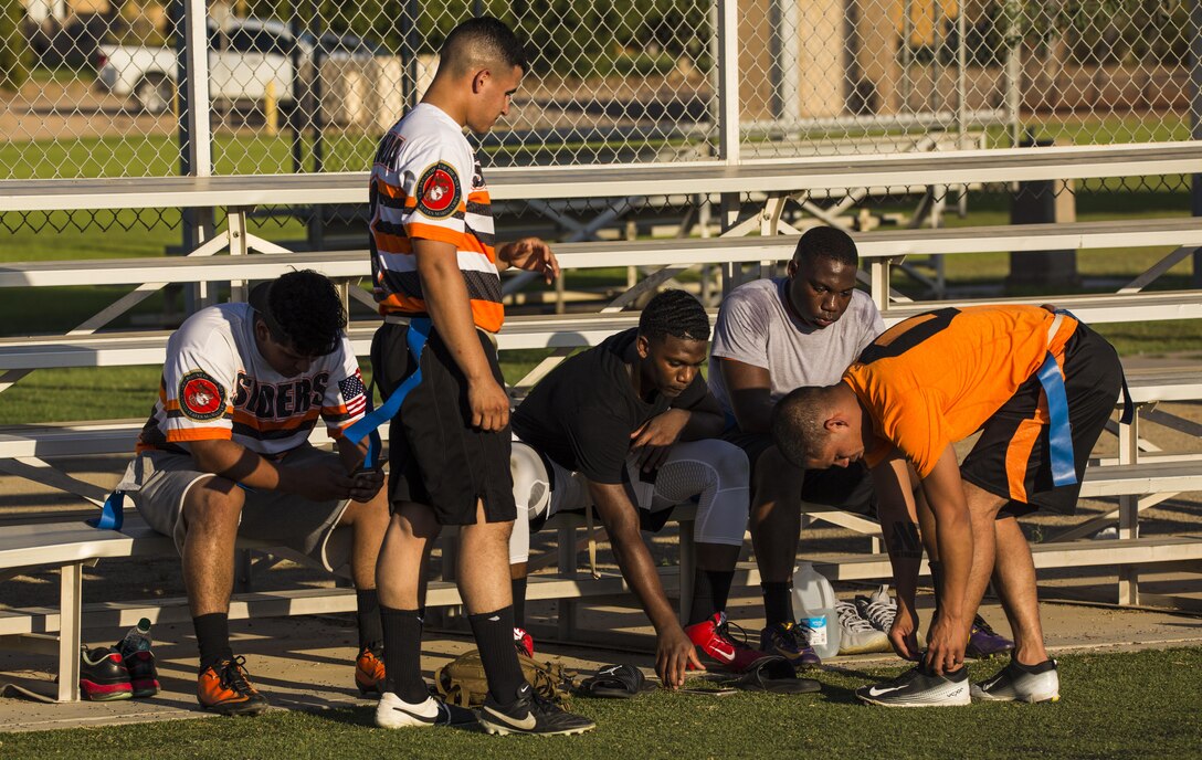 U.S. Marines assigned to Headquarters & Headquarters Squadron (H&HS) rest in between halves and strategize the remainder of their game against the Marine Aviation Logistics Squadron (MALS) 13 on Ramada Field at Marine Corps Air Station Yuma, Ariz., Aug. 7, 2017. Intramural flag football is hosted by MCAS Yuma Athletic Department, and is one of the 14 sports that Marines and Sailors can participate in throughout the year. (U.S. Marine Corps photo taken by Lance Cpl. Isaac D. Martinez)