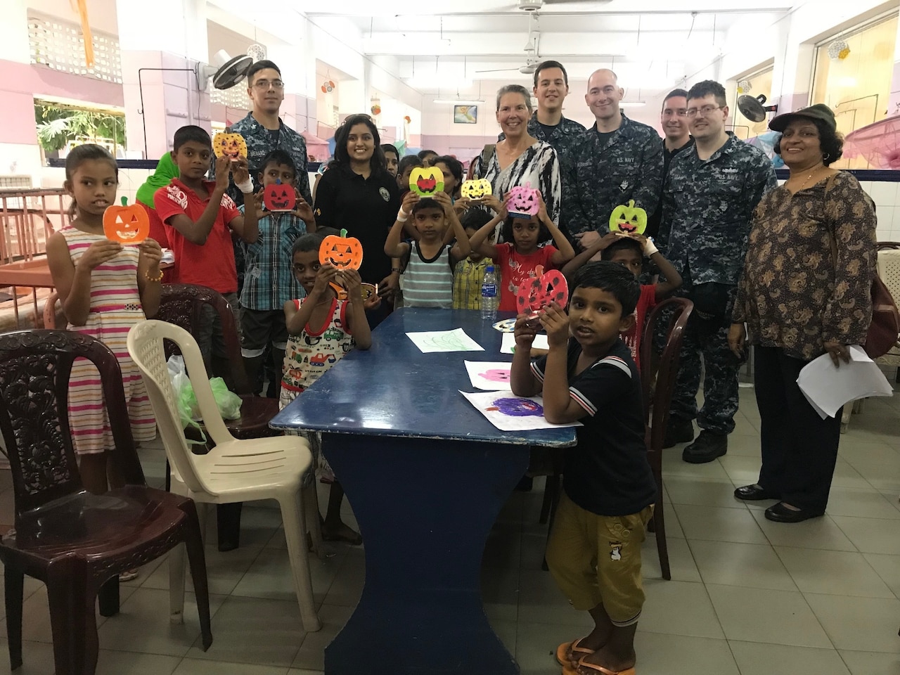 Sailors, embassy volunteers and patients display crafts made during visit to Sri Lankan children's hospital.