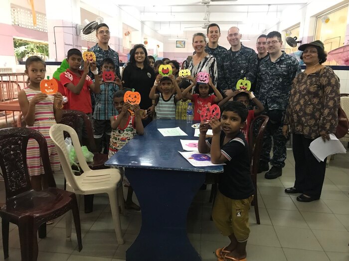 Sailors, embassy volunteers and patients display crafts made during visit to Sri Lankan children's hospital.