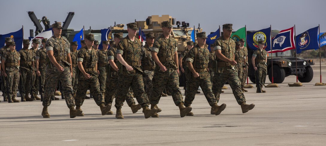 U.S. Marines assigned to Marine Attack Squadron (VMA) 214, Marine Attack Squadron 311, Marine Fighter Attack Squadron (VMFA) 211, Marine Aviation Logistics Squadron (MALS) 13, Marine Wing Support Sqaudron (MWSS) 371, and Marine Unmanned Aerial Vehicle Squadron (VMU) 1 assemble during the Marine Aircraft Group (MAG) 13 chnage of command ceremony on the flightline at Marine Corps Air Station Yuma, Ariz., July 28, 2017. Col. Marcus B. Annibale, the outgoing commanding officer of MAG-13, relinquished command to the oncoming commanding officer, Col. William R. Sauerland. (U.S. Marine Corps photo taken by Pfc. Sabrina Candiaflores)