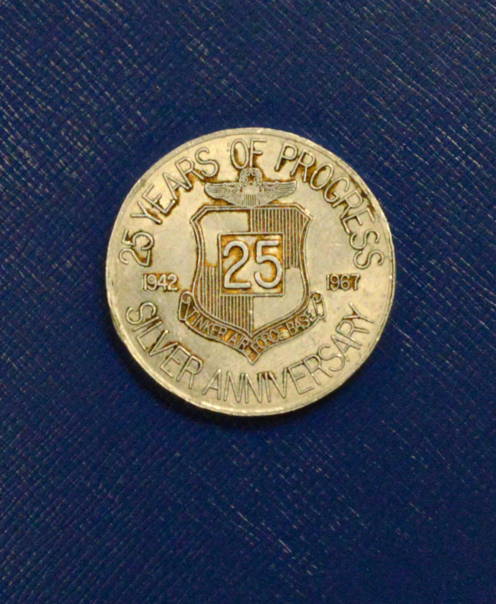 A coin from Tinker’s 25th Silver Anniversary. The front is a silhouette of Maj. Gen. Clarence Tinker and the back is Tinker’s emblem with the years of operational service, 1942 to 1967, at the time the coin was made.