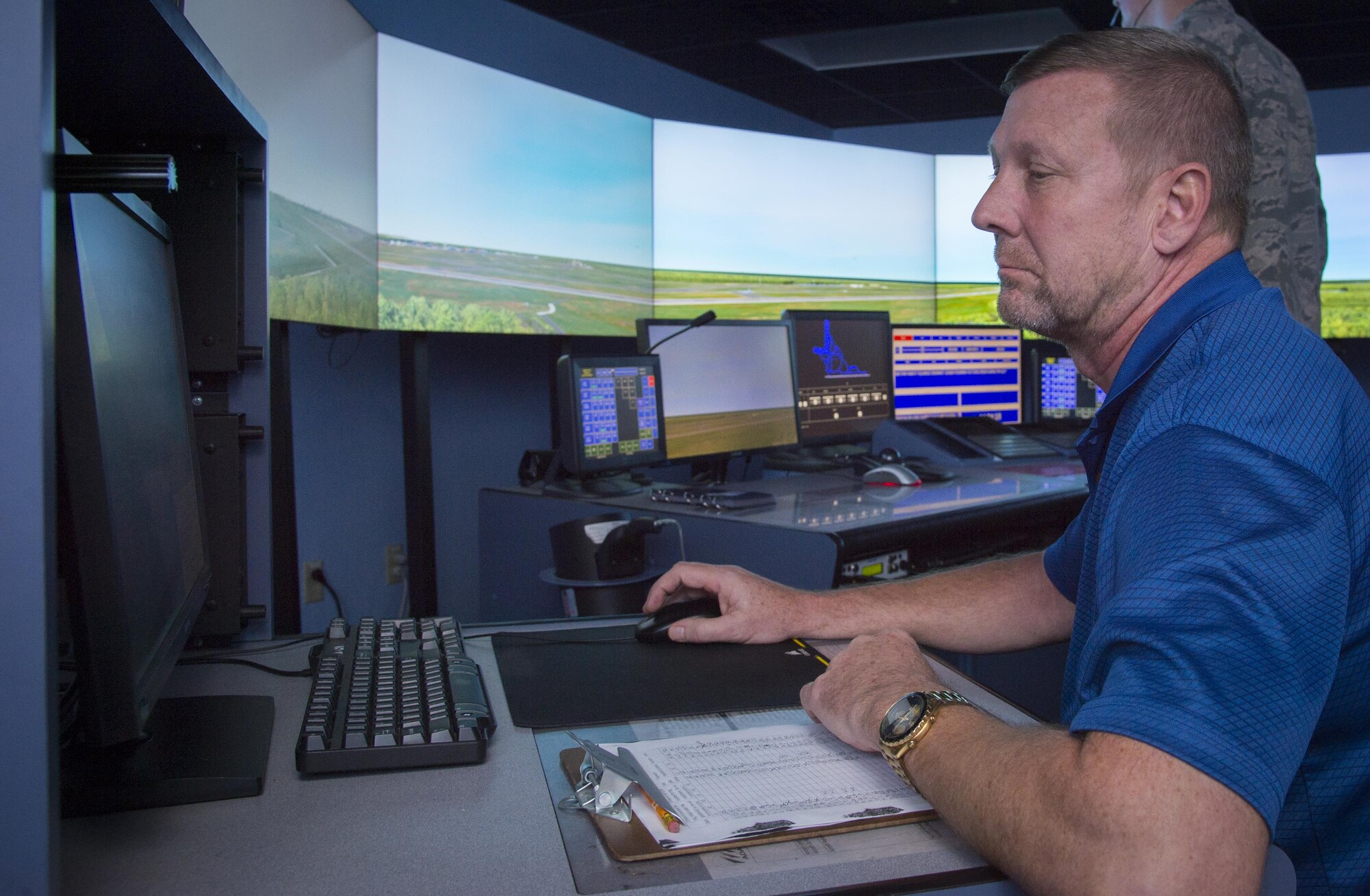 Bruce Morrow, a supervisor air traffic control specialist and the air traffic control simulation equipment program manager assigned to the 6th Operations Support Squadron, controls an air traffic control simulator as Airmen train through a scenario at MacDill Air Force Base, Fla., Oct. 27, 2017. Controllers can customize scenarios for individuals to help teach them a particular concept or skill. (U.S. Air Force photo by Senior Airman Mariette Adams)