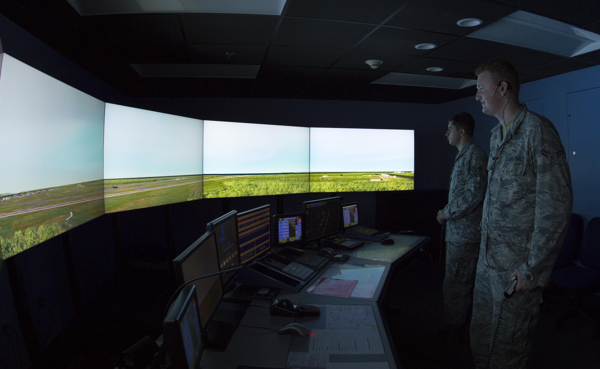 U.S. Air Force Senior Airman Vincent Magenti, an air traffic controller, and Airman 1st Class Tyler Abell, an air traffic controllers assigned to the 6th Operations Support Squadron, focus on a simulated air field during an air traffic control simulator scenario at MacDill Air Force Base, Fla., Oct. 27, 2017. The simulator is a tool used by Airmen to train and demonstrate proficiency in numerous situations, prior to working in the field. (U.S. Air Force photo by Senior Airman Mariette Adams)