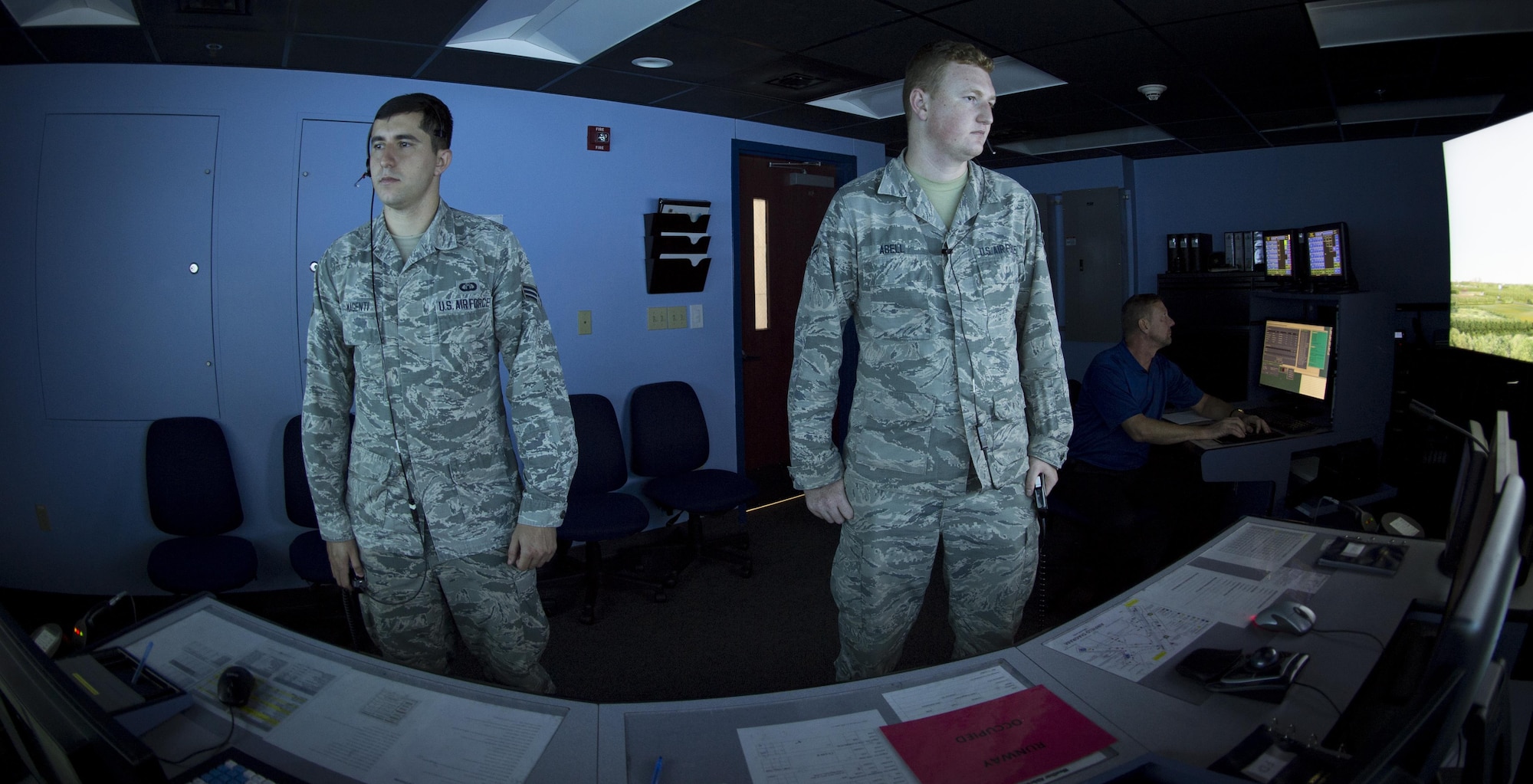 U.S. Air Force Senior Airman Vincent Magenti, an air traffic controller, and Airman 1st Class Tyler Abell, an air traffic controller apprentice, both assigned to the 6th Operations Support Squadron, perform an air traffic control simulator scenario at MacDill Air Force Base, Fla., Oct. 27, 2017. The simulator uses five screens and nine computers to provide the training to air traffic controllers on a daily basis. (U.S. Air Force photo by Senior Airman Mariette Adams