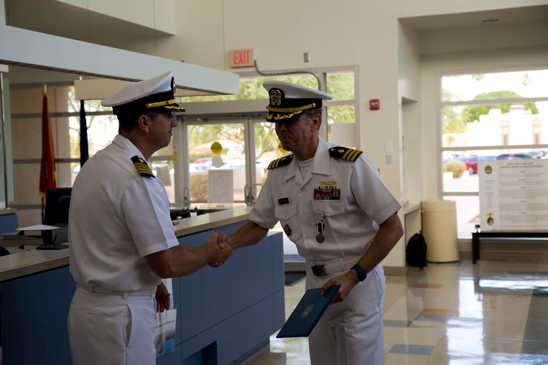 U.S. Navy Capt. Frank P. Pearson, Commanding Officer Naval Hospital Camp Pendleton, shakes the hand of outgoing Cmdr. Christopher J. Maldarella during the change of charge ceremony at Branch Health Clinic Yuma on Marine Corps Air Station Yuma Ariz., July 13, 2017. (U.S. Marine Corps photo by Lance Cpl. Joel Soriano)