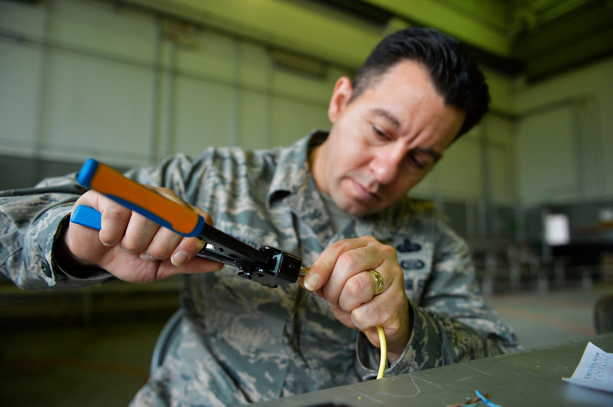 U.S. Air Force Senior Master Sgt. Tito Bonilla, 1st Combat Communications Squadron superintendent of mission planning and operations, assembles a cable during an exercise on Rhine Ordnance Barracks, Germany, Oct. 26, 2017. The exercise tested the squadron’s mission readiness and ability to integrate with other branches of service. (U.S. Air Force photo by Airman 1st Class Joshua Magbanua)