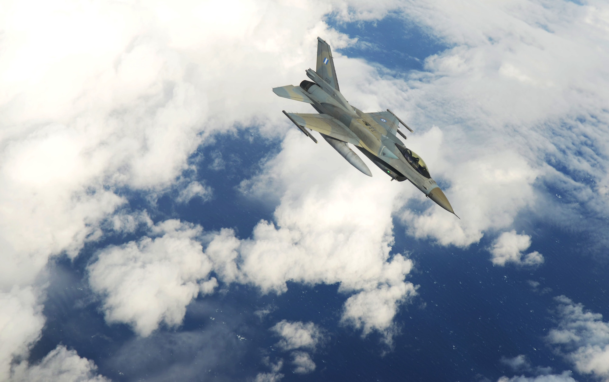 Hellenic air force F-16C Fighting Falcons fly alongside a U.S. Air Force KC-135 Stratotanker from the 100th Air Refueling Wing Oct. 26, 2017, over the Mediterranean Sea. During this flight, the KC-135 participated in aerial refueling training with 22 F-16s. (U.S. Air Force photo by Senior Airman Tenley Long)