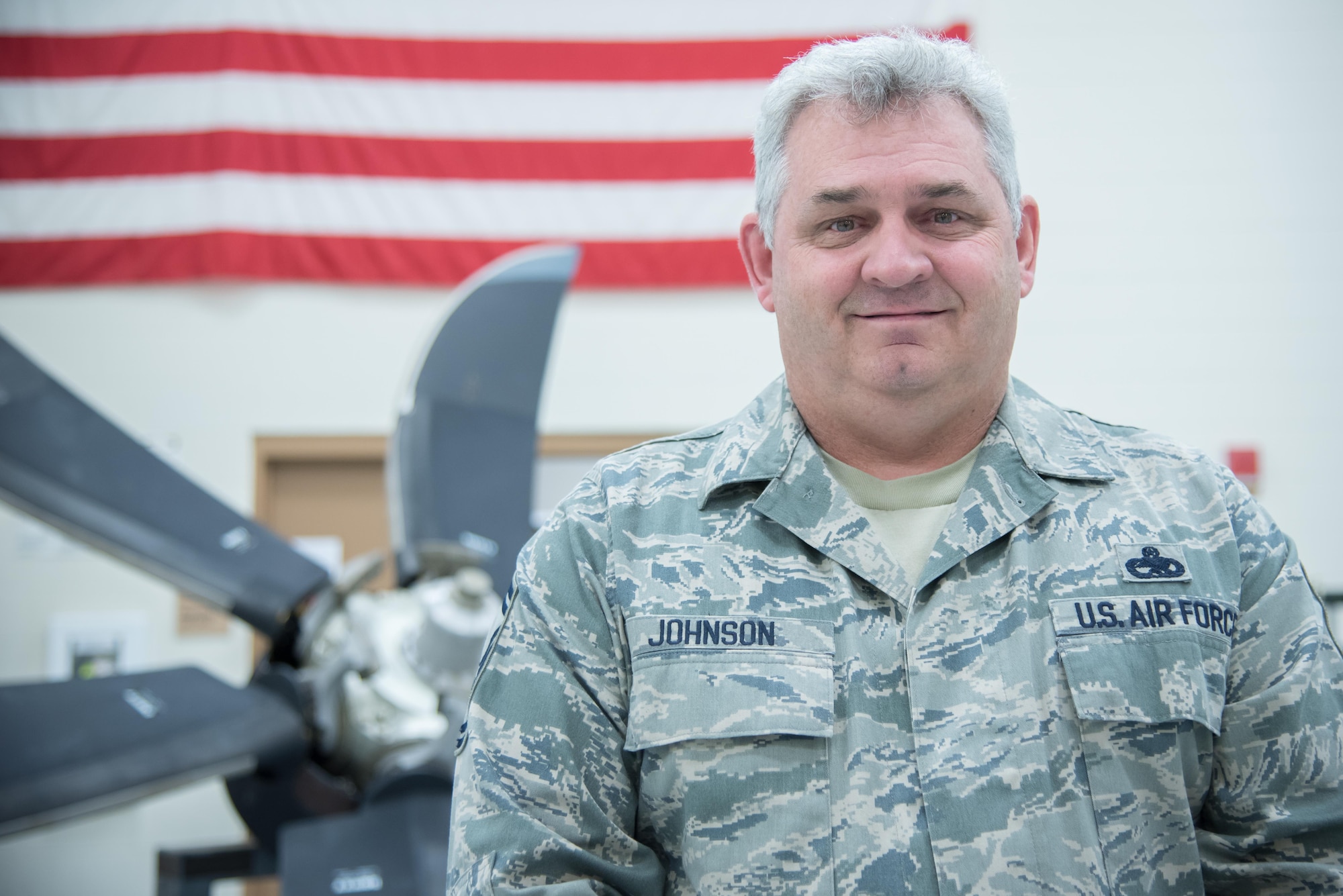 Senior Master Sgt. Eric H. Johnson III, 403rd Maintenance Sqadron Propulsion Flight chief, poses for a photo in front of a C-130J Super Hercules aircraft propeller Oct. 17, 2017 at Keesler Air Force Base Mississippi. (U.S. Air Force photo/Staff Sgt. Heather Heiney)