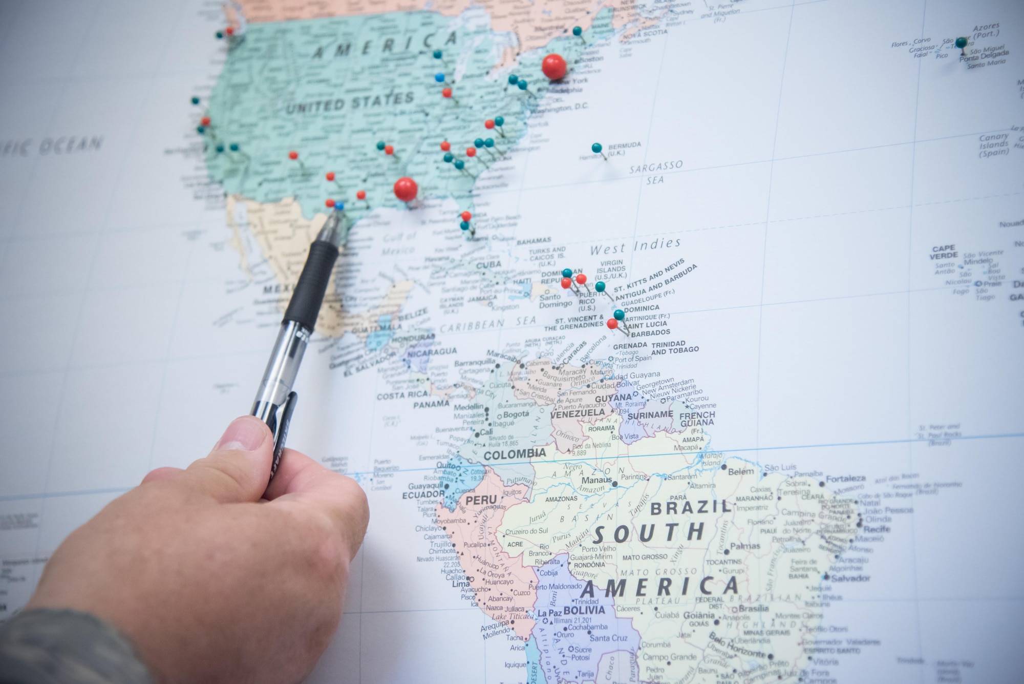 Senior Master Sgt. Eric H. Johnson III, 403rd Maintenance Sqadron Propulsion Flight chief, points at a pushpin map where he tracks the places he's been throughout his 32-year Air Force career Oct. 17, 2017 at Keesler Air Force Base Mississippi. (U.S. Air Force photo/Staff Sgt. Heather Heiney)