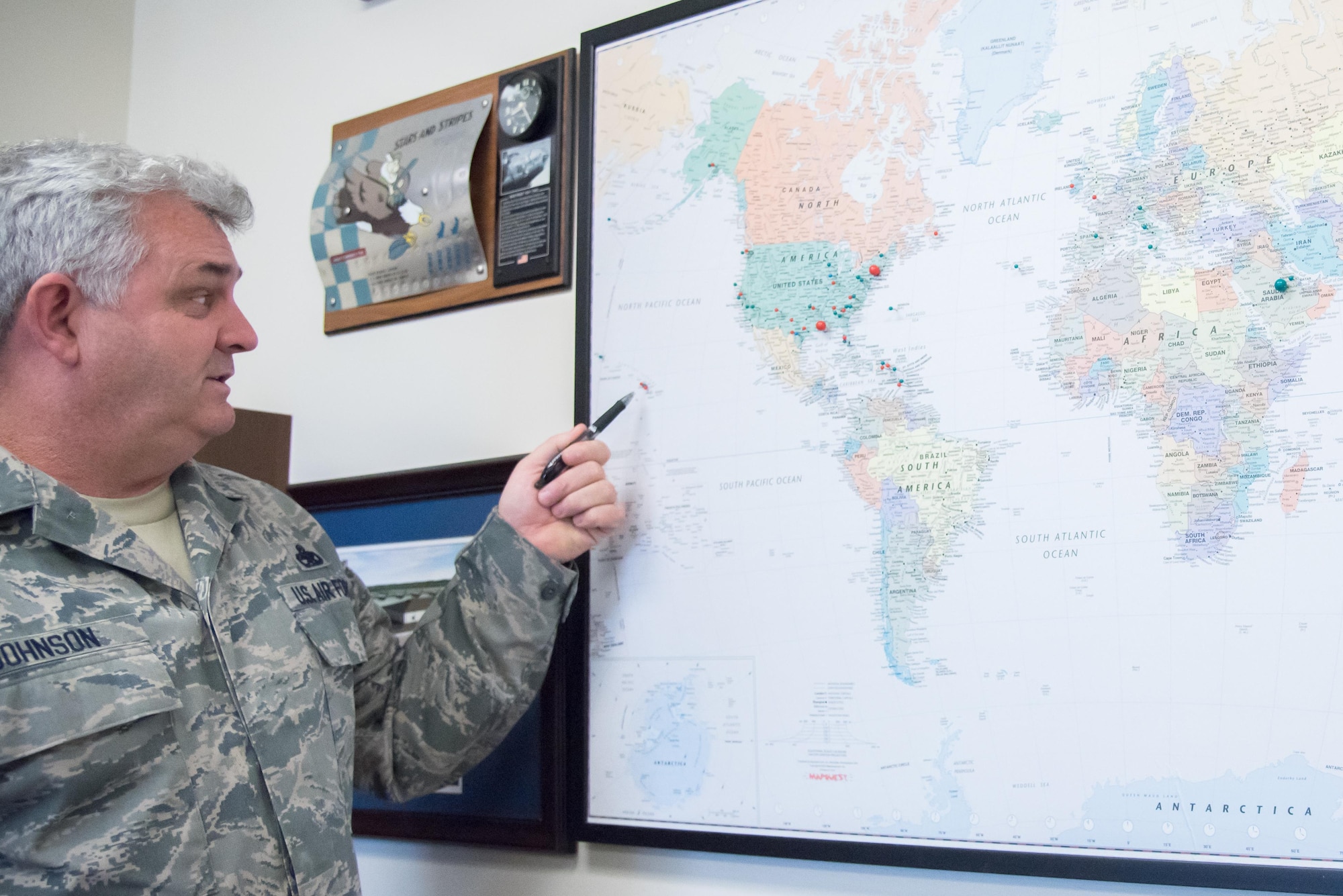Senior Master Sgt. Eric H. Johnson III, 403rd Maintenance Sqadron Propulsion Flight chief, points at a pushpin map where he tracks the places he's been throughout his 32-year Air Force career Oct. 17, 2017 at Keesler Air Force Base Mississippi. (U.S. Air Force photo/Staff Sgt. Heather Heiney)