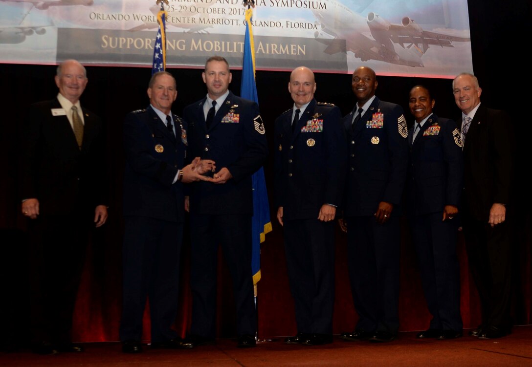 Air Force Chief of Staff Gen. David L. Goldfein presents Master Sgt. Louis
Davis, 9th Airlift Squadron flight engineer, with the 2016 General Robert
"Dutch" Huyser Outstanding Aircrew Member Award