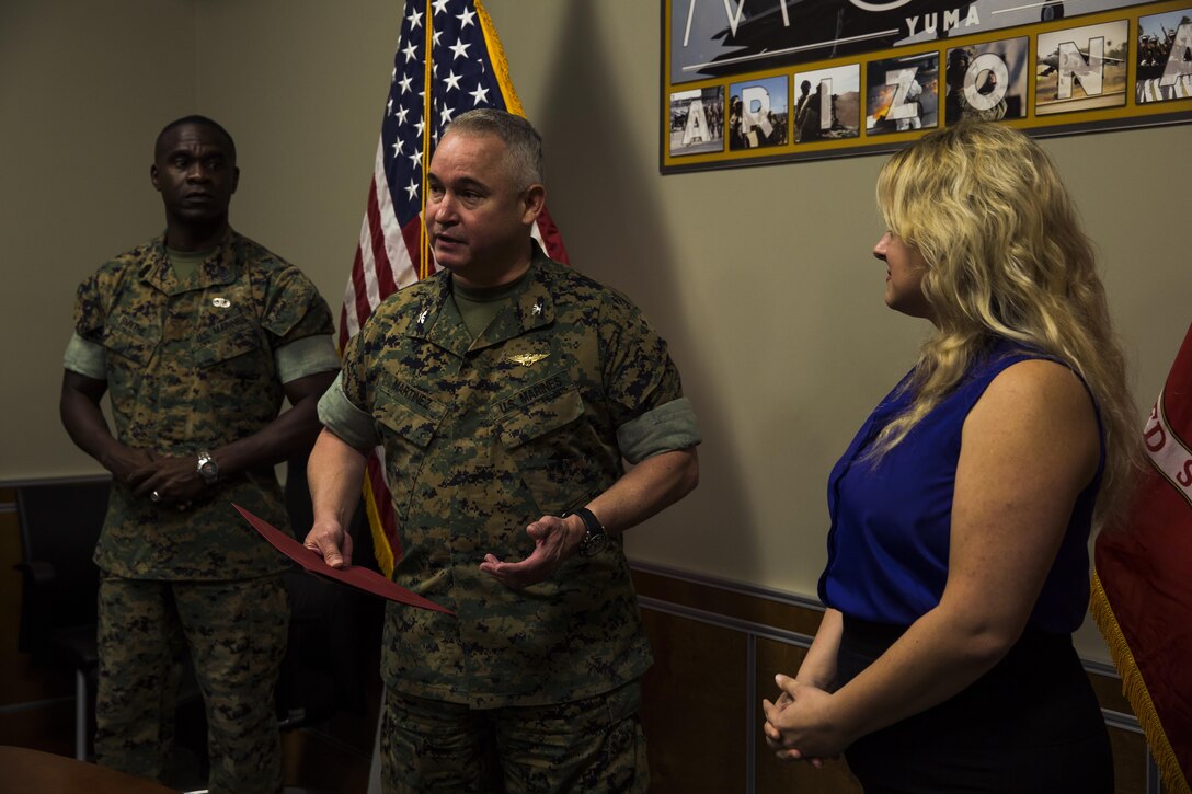 U.S. Marine Corps Col. Ricardo Martinez, the commanding officer of Marine Corps Air Station Yuma, Ariz., recognizes Lisa Tourtelot, the public affairs assistant for MCAS Yuma Public Affairs and Combat Camera, as the MCAS Yuma Employee of the 2nd Quarter, May 3, 2017. (U.S. Marine Corps photo taken by Lance Cpl. Christian Cachola)