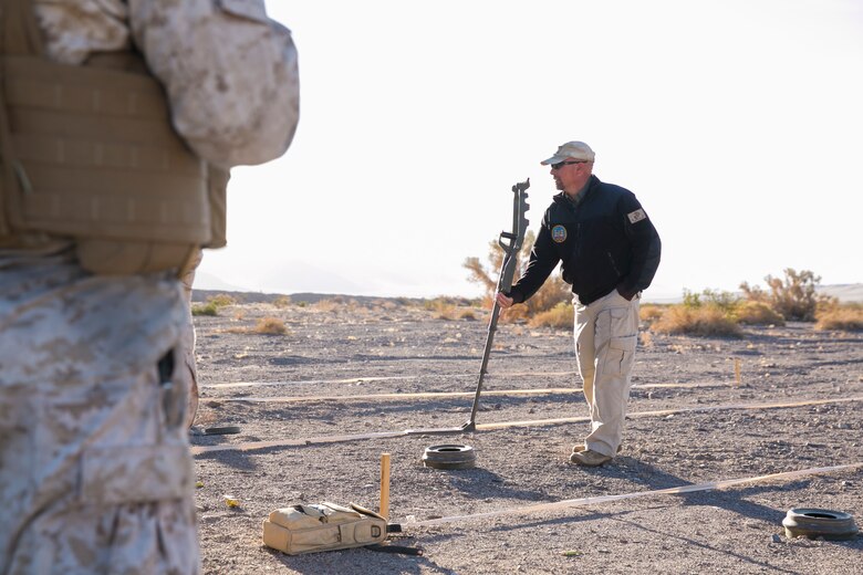 Scott Wheeler, counter improvised explosive device instructor, Marine Corps Engineering School, demonstrates how to use a compact metal detector for Marines from Combat Logistics Battalion 5, which is based out of Marine Corps Base Camp Pendleton, Calif., at Range 114 aboard the Marine Corps Air Ground Combat Center, Twentynine Palms, Calif., Oct.21, 2017. CLB-5’s training, which was part of Integrated Training Exercise 1-18, was focused on using compact metal detectors to detect improvised explosive devices, evacuating personnel from a vehicle that had been struck by an IED and moving a convoy through a kill zone after receiving contact. (U.S. Marine Corps photo by Lance Cpl. Isaac Cantrell)