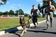 Miko, 4th Security Forces Squadron military working dog, Senior Airman Preston Pearce, 4th SFS MWD handler, center, and Staff Sgt. Austin Craven, 4th SFS MWD trainer, right, embark on a 2-mile run during the last portion of the East Coast Iron Dog competition, Oct. 25, 2017, at Seymour Johnson Air Force Base, North Carolina. The competition consisted of a narcotics and explosive detection contest, high-risk patrol scenario with tactical movements, hardest-hitting dog contest, and ended with a 2-mile endurance run. (U.S. Air Force photo by Airman 1st Class Kenneth Boyton)