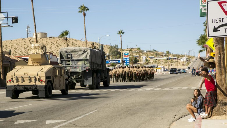 Families wave at the Marines passing by during the annual Pioneer Days Parade in Twentynine Palms, Calif., Oct. 21, 2017. Pioneer Days recognizes those who settled in the area and developed the community as it is today. (U.S. Marine Corps photo by Pfc. Rachel K. Young)
