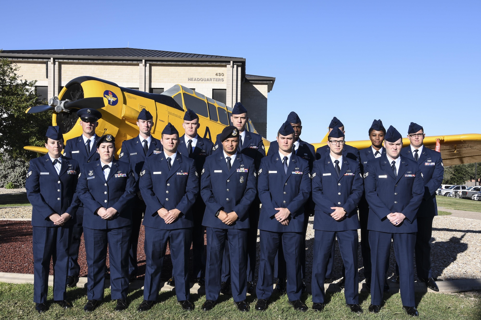Airman Leadership School Class 17-G stands before the T-6 Texan static plane display on Goodfellow Air Force Base, Texas, Oct. 16, 2017. ALS is a six-week course designed to prepare senior airmen to assume supervisory duties by offering instruction in leadership, followership, written and oral communication skills, and the profession of arms.  (U.S. Air Force photo by Airman 1st Class Zachary Chapman/Released)