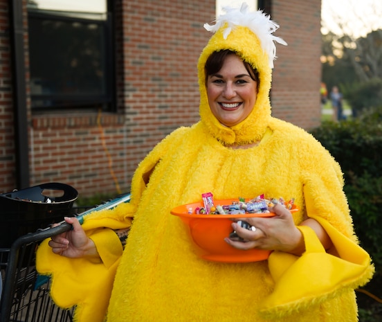 Angela Aschenbrenner, Joint Base Charleston library director, smiles with a bowl of candy outside the library at JB Charleston, S.C., Oct. 27, 2017.