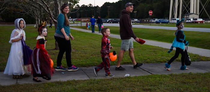 Fall Fest attendees leave the event with smiles on their faces outside the library at Joint Base Charleston, S.C., Oct. 27, 2017.