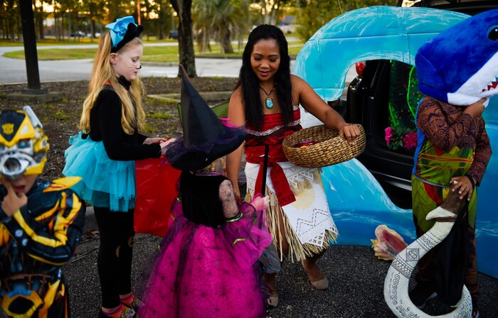 Volunteers distribute candy to families outside the library at Joint Base Charleston, S.C., Oct. 27, 2017.