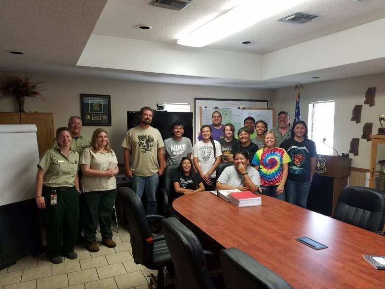 Michael Fedoroff poses with the Historic Preservation staff and children from the Choctaw Nation of Oklahoma, the TNTCX, and the U.S. Forest Service. The photo was taken at the Desoto National Forest after a field visit to Choctaw Ancestral lands.