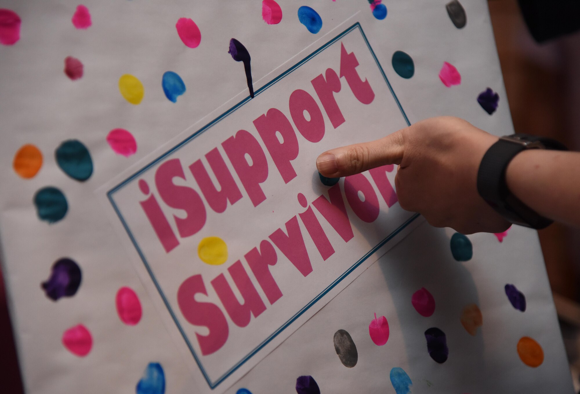 Sarah Abel, 81st Medical Operations Squadron internal medicine clinic flight commander, applies her thumb print on an “I Support Survivors” poster in honor of her mother during the 6th Annual Mammothon Cancer Screening and Preventative Health Fair at the Don Wylie Auditorium Oct. 27, 2017, on Keesler Air Force Base, Mississippi. The 81st Medical Group hosted the walk-in event which included screenings for multiple types of cancer and chronic diseases in honor of Breast Cancer Awareness Month. Flu shots were also provided upon request. (U.S. Air Force photo by Kemberly Groue)