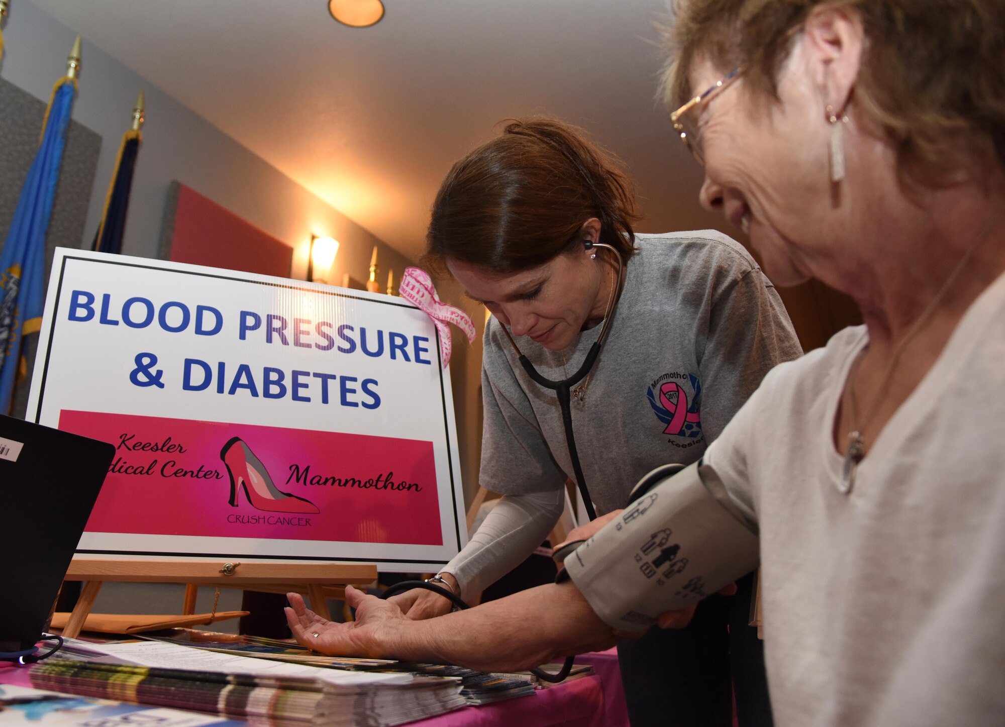 Stacy Powell, 81st Medical Operations Squadron patient discharge planner, takes a blood pressure reading on Rose Cardinali, spouse of retired U.S. Army Warrant Officer Augustine Cardinali, (deceased), during the 6th Annual Mammothon Cancer Screening and Preventative Health Fair at the Don Wylie Auditorium Oct. 27, 2017, on Keesler Air Force Base, Mississippi. The 81st Medical Group hosted the walk-in event which included screenings for multiple types of cancer and chronic diseases in honor of Breast Cancer Awareness Month. Flu shots were also provided upon request. (U.S. Air Force photo by Kemberly Groue)