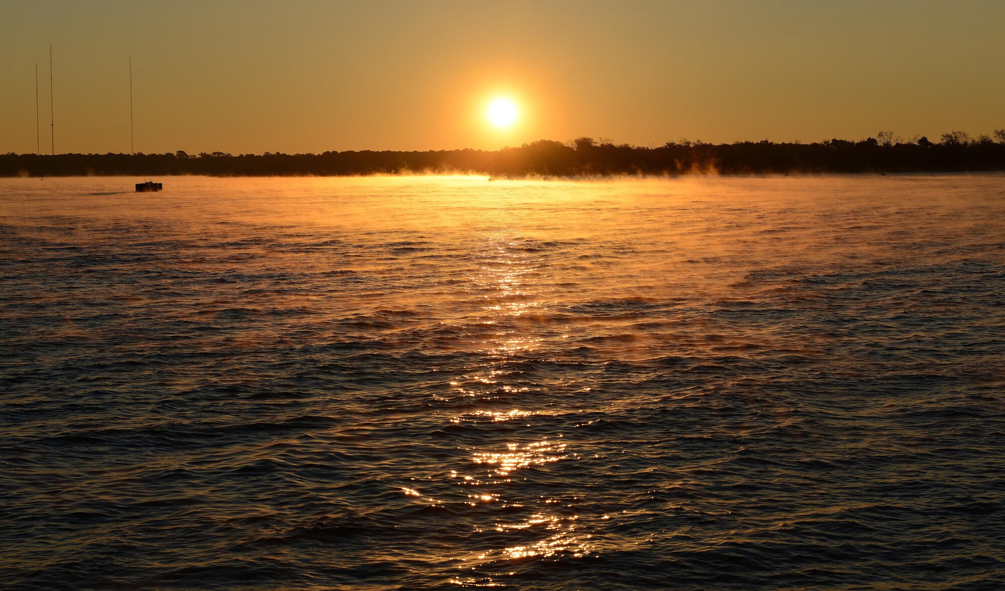 The sun rises over the shore of Cooper River at Joint Base Charleston Naval Weapons Station, S.C., Oct. 30, 2017.