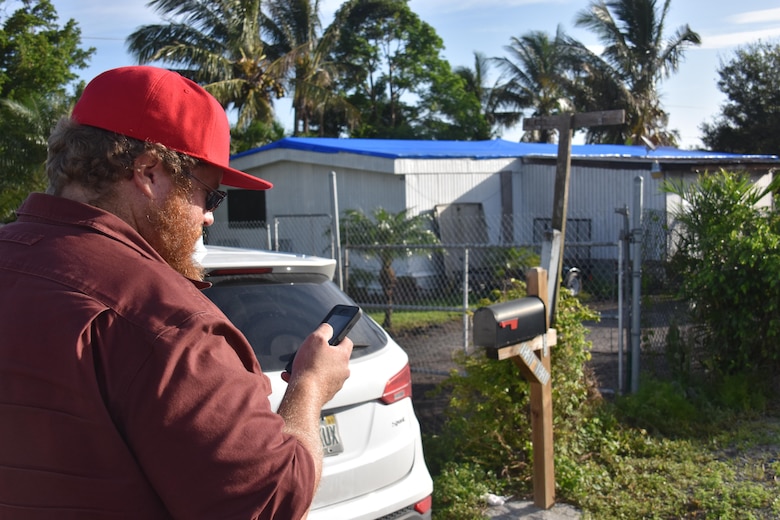 Matt Bonner, a civil engineer with the U.S. Army Corps of Engineers, Albuquerque District, and a quality assurance inspector in Florida, reviews a completed blue roof installation in Belle Grade, Florida, Oct. 23, 2017. Bonner volunteered to support Operation Blue Roof following Hurricane Irma. To date, the Corps has installed more than 11,000 temporary blue roofs for homeowners across Florida.