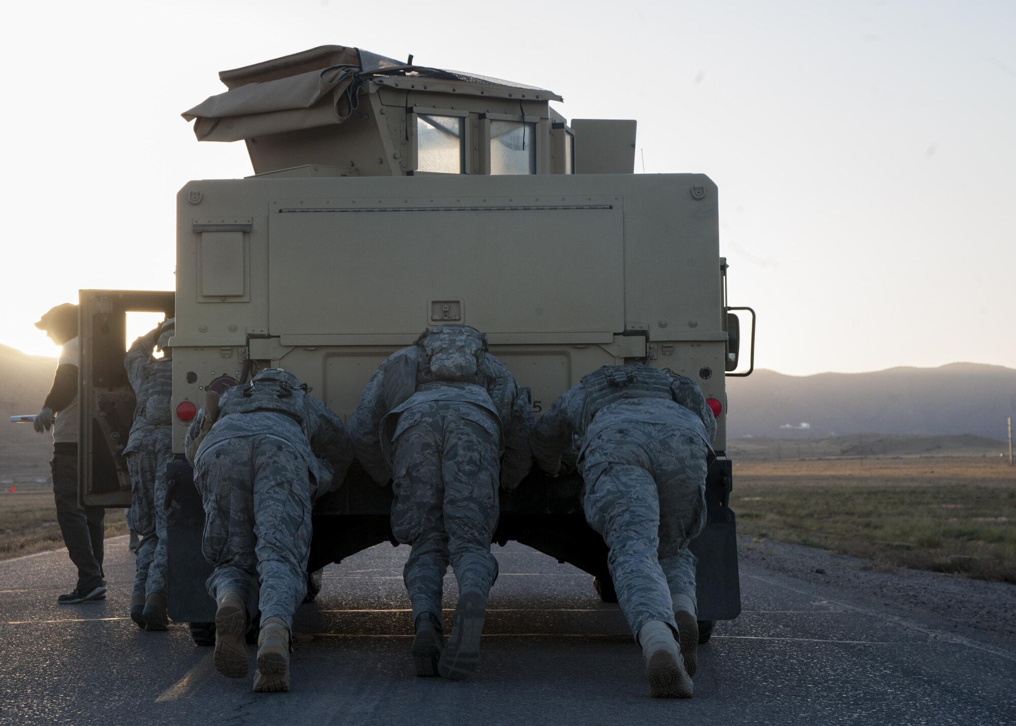 Members of the 377th Weapons Systems Security Squadron participate in the Humvee push portion of the Manzano Challenge at Kirtland Air Force Base, N.M., Oct. 27. The event saw 40 Airmen from Security Forces competing in different skills tests. (U.S. Air Force photo by Staff Sgt. J.D. Strong II)