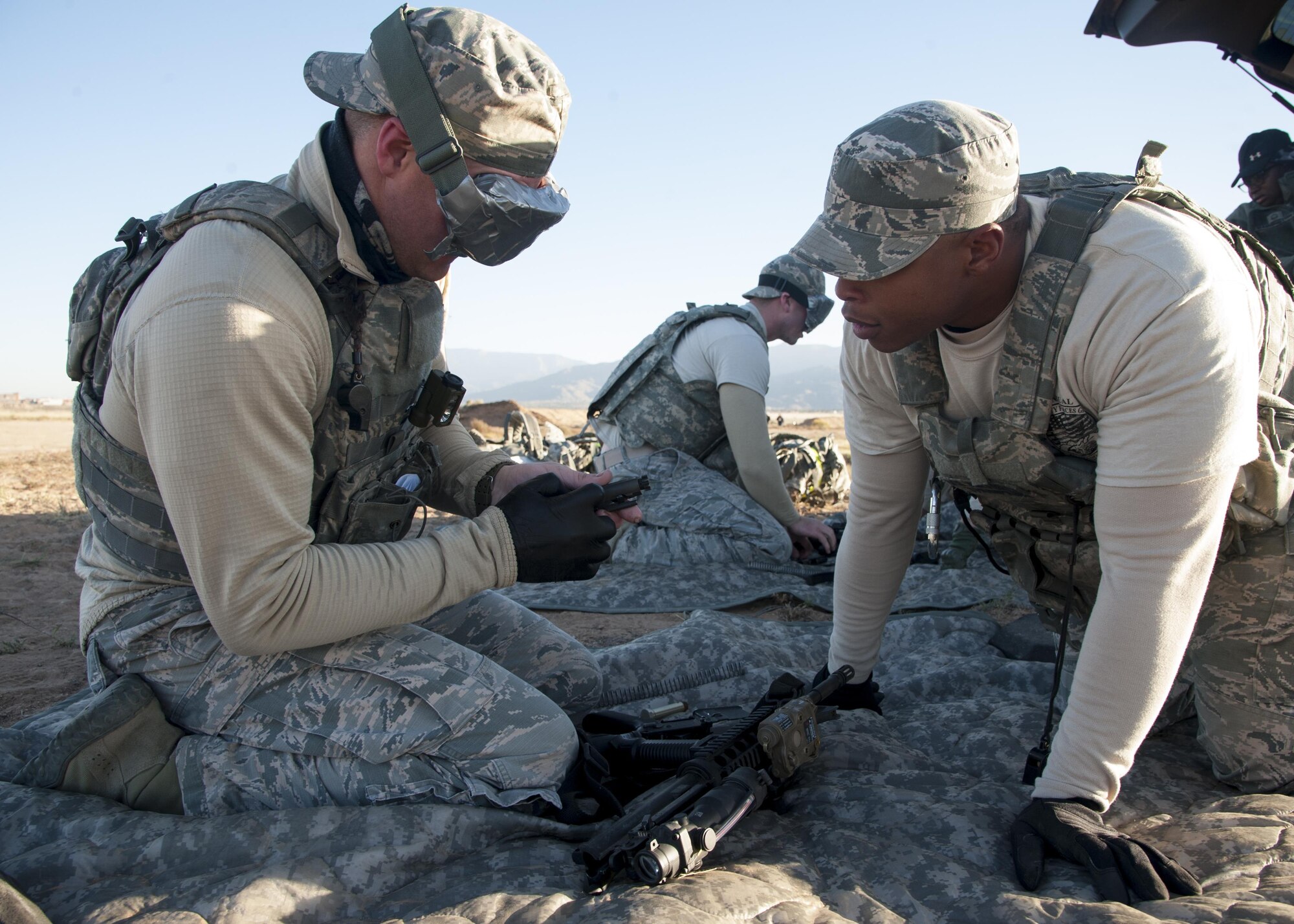 Staff Sgt. Raymond Thompkins, 377th Weapons Systems Security Squadron, verbally assists Senior Airman James Ogg, 377th WSSS, with disassembling an M-4 during the weapons knowledge portion of the Manzano Challenge at Kirtland Air Force Base, N.M., Oct. 27. The event saw 40 Airmen from the 377th Security Forces Group competing in different stations, ranging from weapons skills and land navigation to team tactics and problem solving. (U.S. Air Force photo by Staff Sgt. J.D. Strong II)