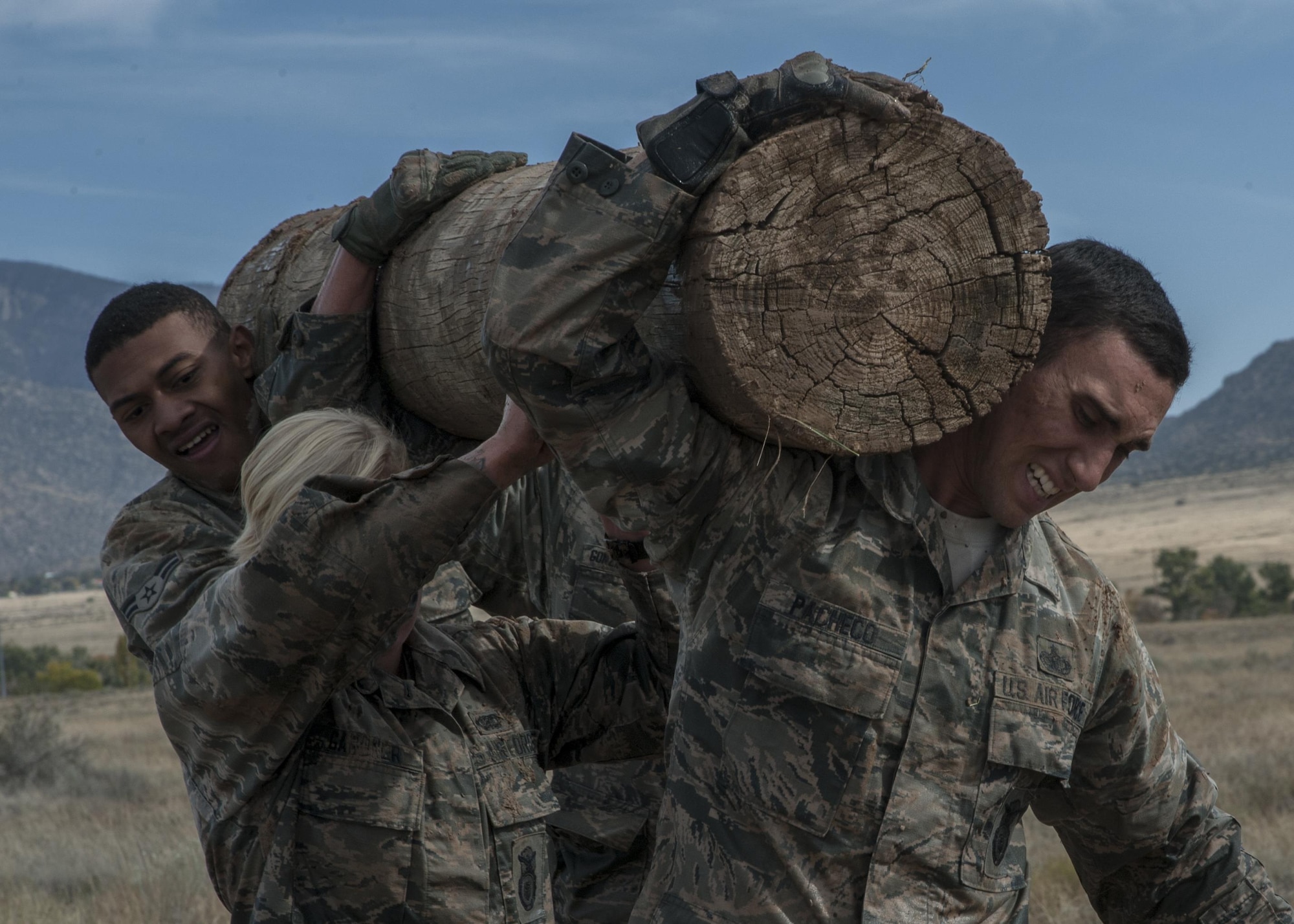 Staff Sgt. Antonio Pacheco, Airman 1st Class Carlie Gardner and Senior Airman Damone Shelton, 377th Weapons Systems Security Squadron, carry a log during the “Team Punisher” portion of the Manzano Challenge at Kirtland Air Force Base, N.M., Oct. 27. It was the second annual Manzano Challenge. (U.S. Air Force photo by Staff Sgt. J.D. Strong II)