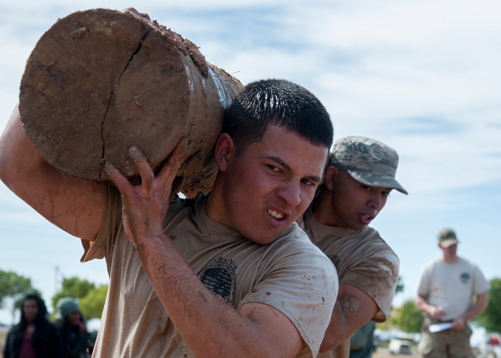 Airman 1st Class Dalton Cruz, 377th Weapons Systems Security Squadron, carries a log with his teammate during the “Team Punisher” portion of the Manzano Challenge at Kirtland Air Force Base, N.M., Oct. 27. The Manzano Challenge required more than 70 volunteers and coordination with 21 base agencies, making the course safe for all participants. (U.S. Air Force photo by Staff Sgt. J.D. Strong II)