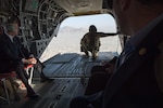 Defense Secretary Jim Mattis and a soldier look out of the tailgate of a CH-47 Chinook helicopter over Afghanistan.