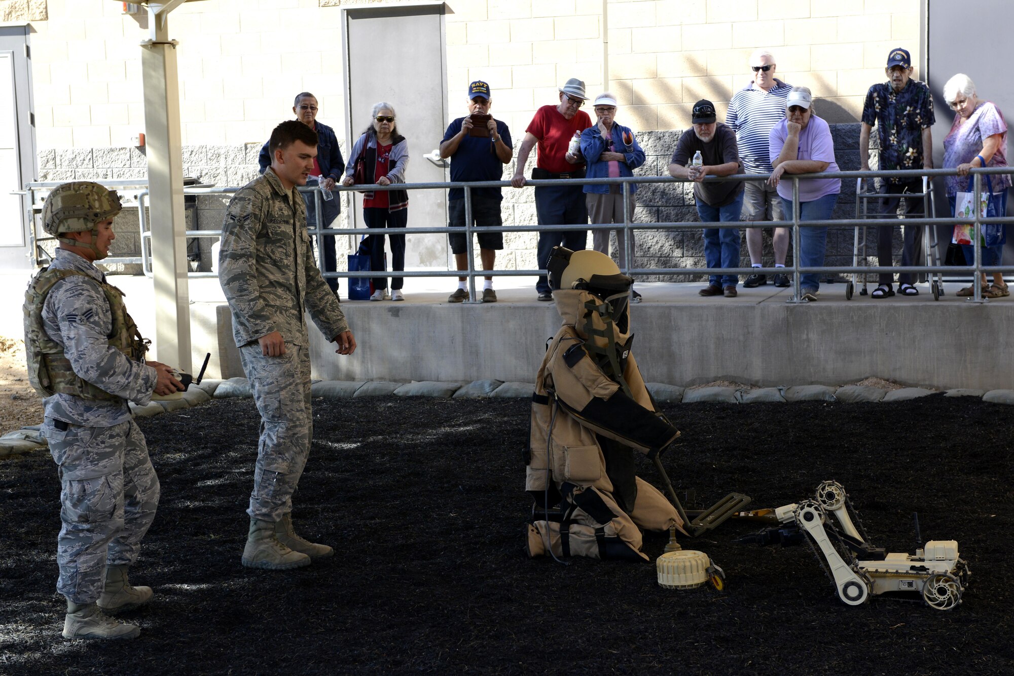 Airman 1st Class Zachary Riesselmann, 56th Civil Engineer Squadron explosive ordnance disposal technician (left), and Senior Airman Daniel Keum, 56th CES EOD technician, demonstrate how to operate a micro tactical ground robot at Luke Air Force Base, Ariz., Oct. 28, 2017. Additional EOD equipment was showcased during the Retiree Appreciation Day event held at the Navy Operations Support Center. (U.S. Air Force photo/Airman 1st Class Pedro Mota)