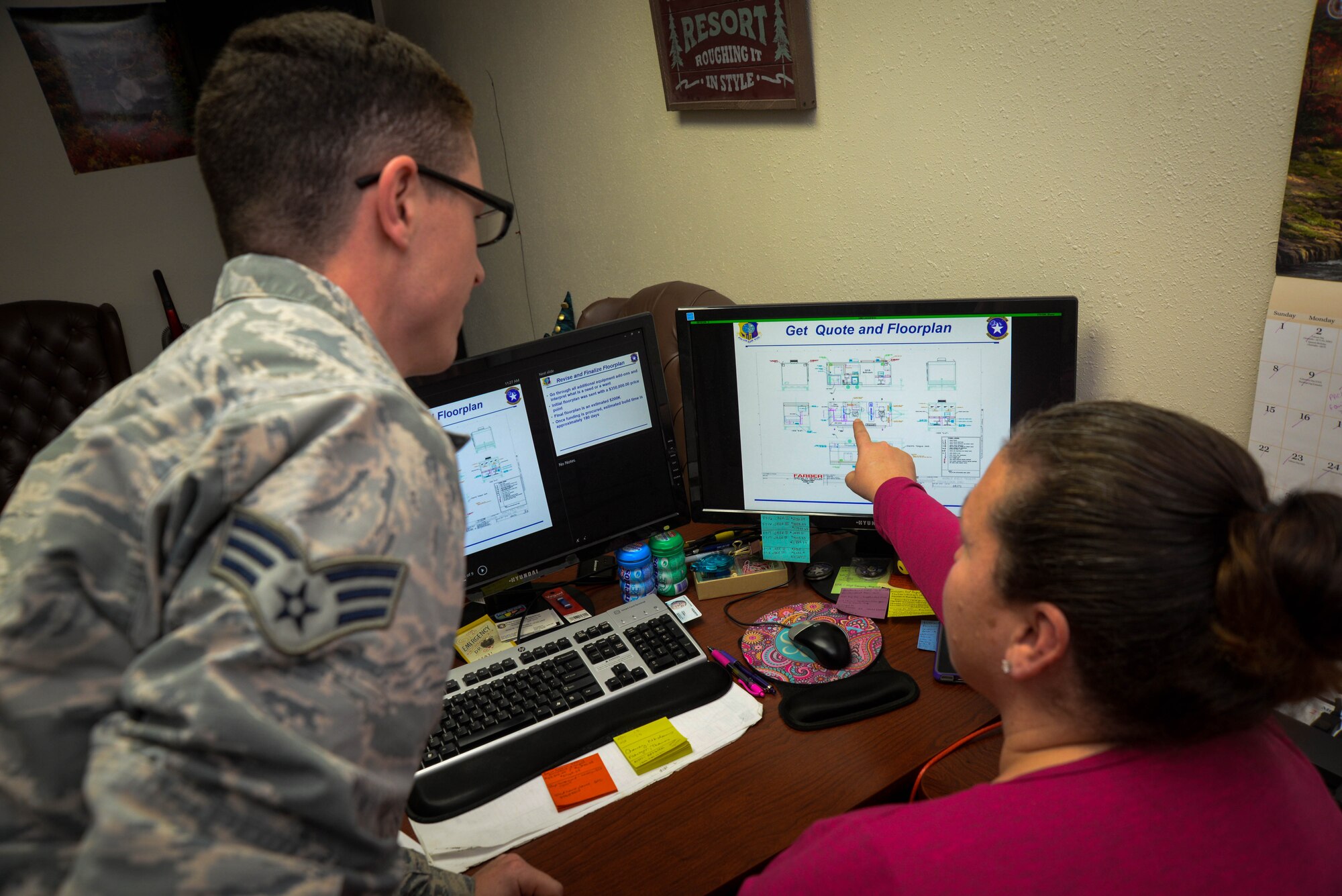 Senior Airman Adrian Durr, 673d Security Forces Squadron Vehicle Control non-commissioned officer in-charge, and Shannon Anthony, 673d SFS resource advisor, review plans for a mobile command center at Joint Base Elmendorf-Richardson, Alaska, Oct. 26, 2017. A three-person 673d SFS team dedicated 100 hours to researching, proposing plans for, and acquiring a mobile command center, set to arrive between April and June 2018. In the event of a contingency or natural disaster, this new asset serves as a high-tech central point of communication for responding personnel and can provide support for incidents across the state. (U.S. Air Force photo by Senior Airman Curt Beach)