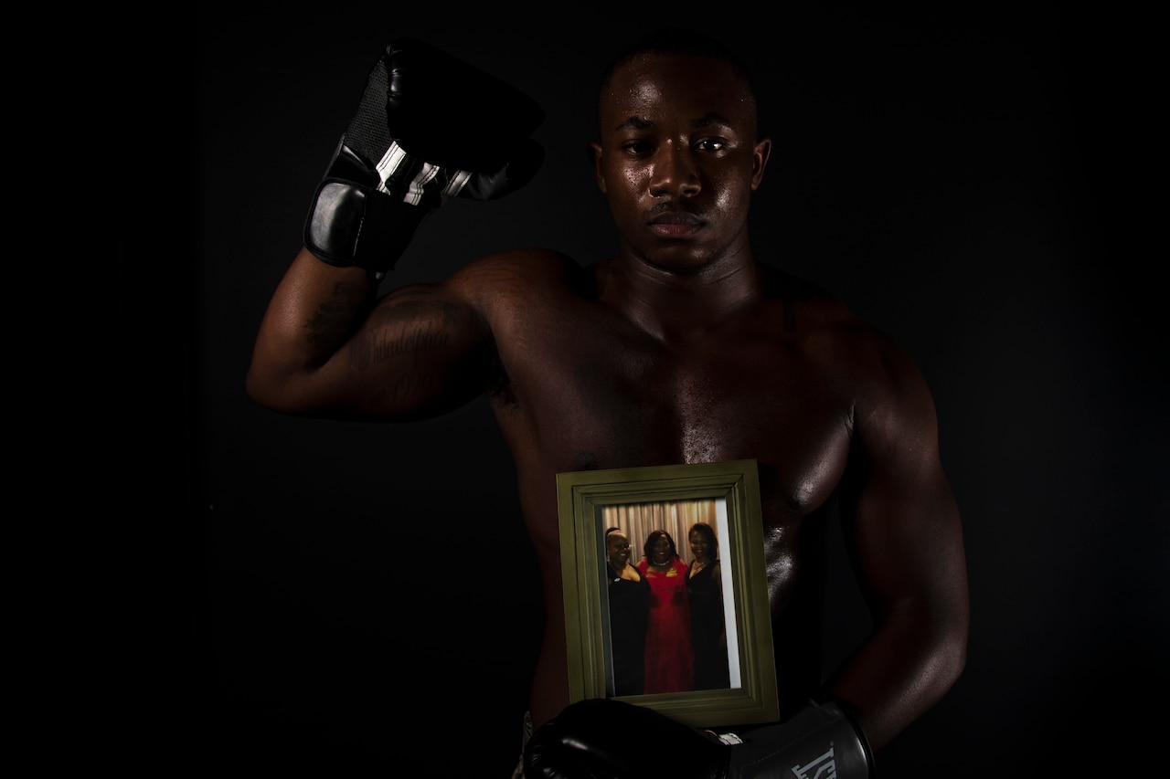 Airman 1st Class Isaiah Randall poses in boxing attire.