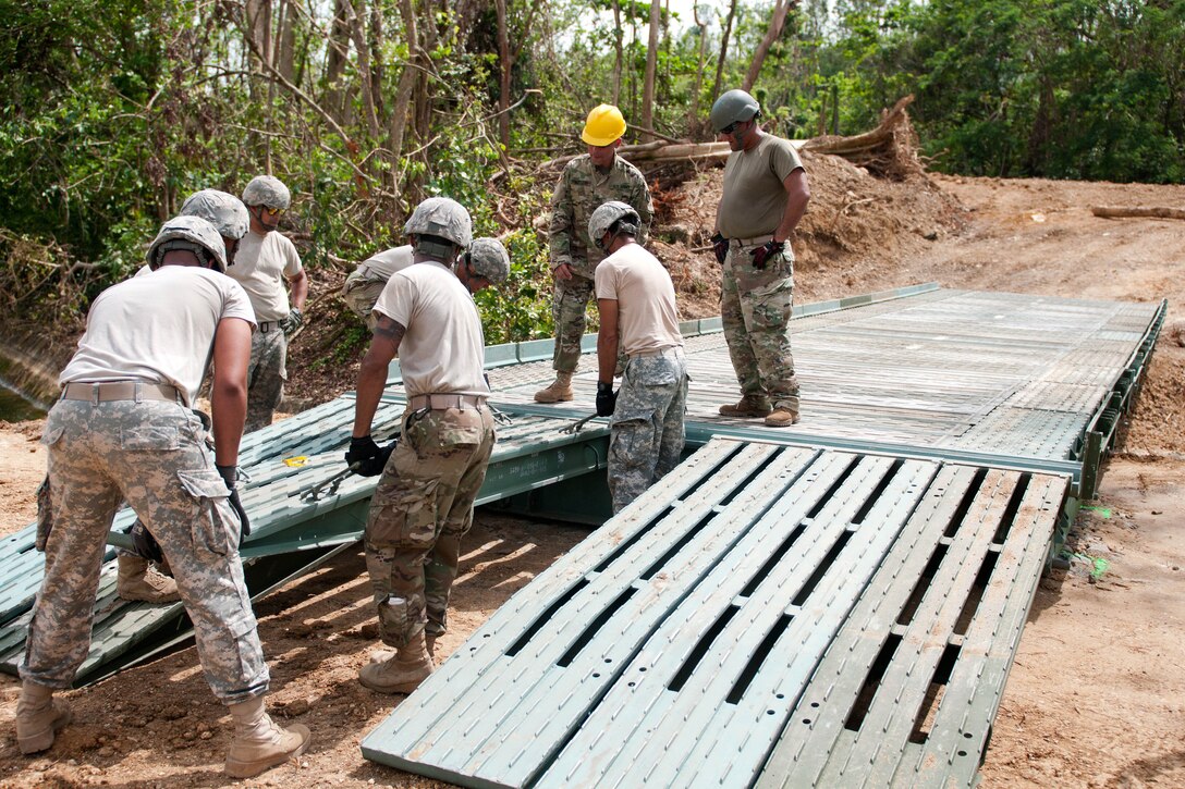 Puerto Rico Army National Guardsmen construct a 40-foot bridge they are building for the citizens of Quebradillas.