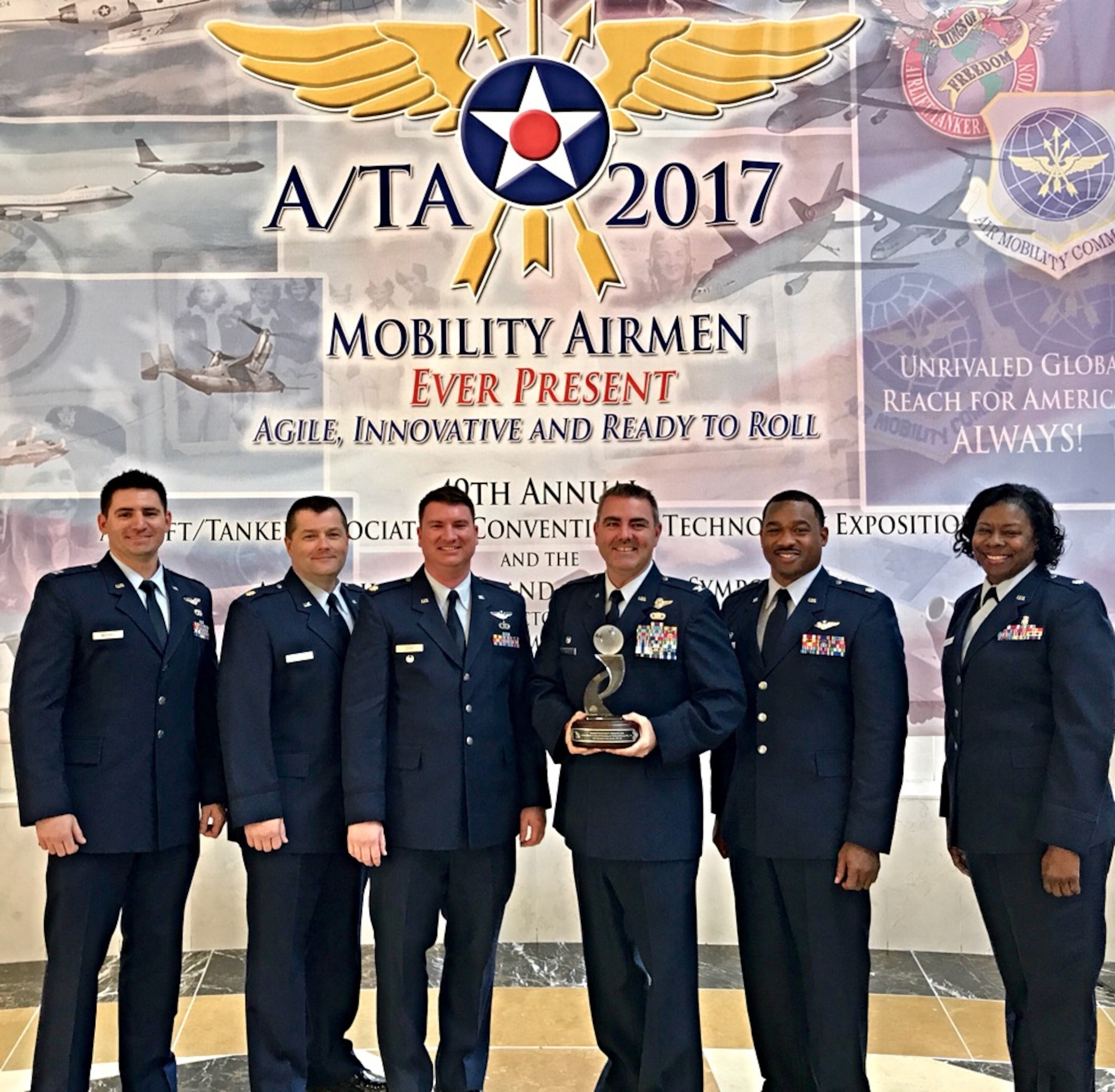Members of the 403rd Operations Group accept the Airlift/Tanker Association's Lt. Gen. James E. Sherrard III Air Force Reserve Command Outstanding Unit Award. his award is presented annually to the most outstanding Air Force Reserve wing or group that distinguished itself in the performance and support of the Mobility Air Forces mission. (U.S. Air Force photo)