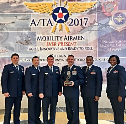 Members of the 403rd Operations Group accept the Airlift/Tanker Association's Lt. Gen. James E. Sherrard III Air Force Reserve Command Outstanding Unit Award. his award is presented annually to the most outstanding Air Force Reserve wing or group that distinguished itself in the performance and support of the Mobility Air Forces mission. (U.S. Air Force photo)