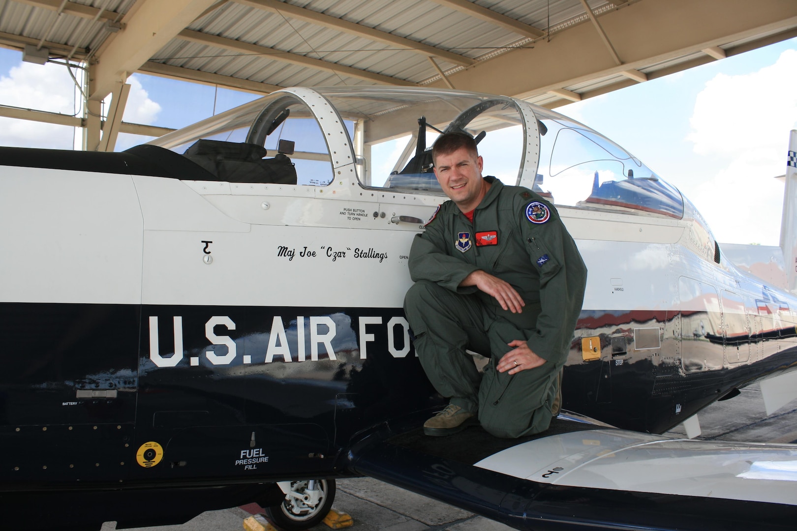 Maj. Joe Stallings, 558th Flying Training Squadron instructor pilot, with a T-6 Texan II on the flight line at Joint Base San Antonio-Randolph, Texas, Oct. 30, 2017.  Stallings was inspired to serve in the Air Force after attending air shows as a child and is the 2017 JBSA Air Show and Open House director of air operations.