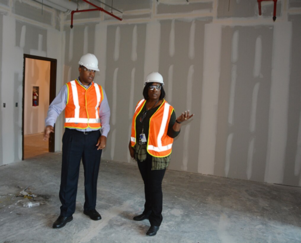 Co-workers look over new office space