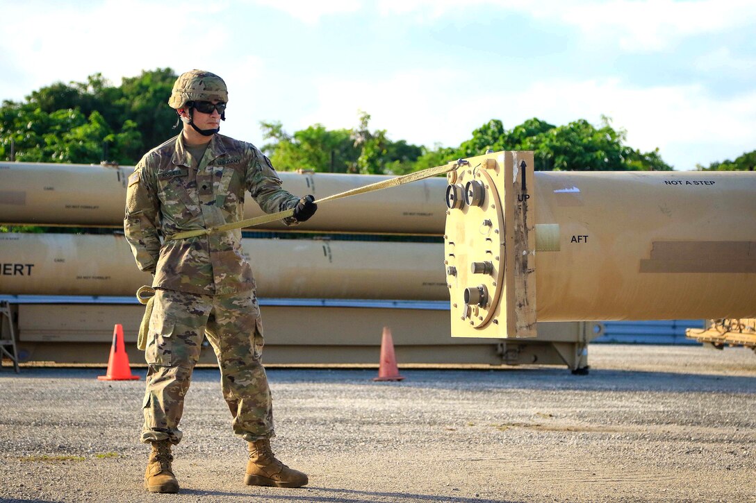 A soldier guides a missile round trainer.