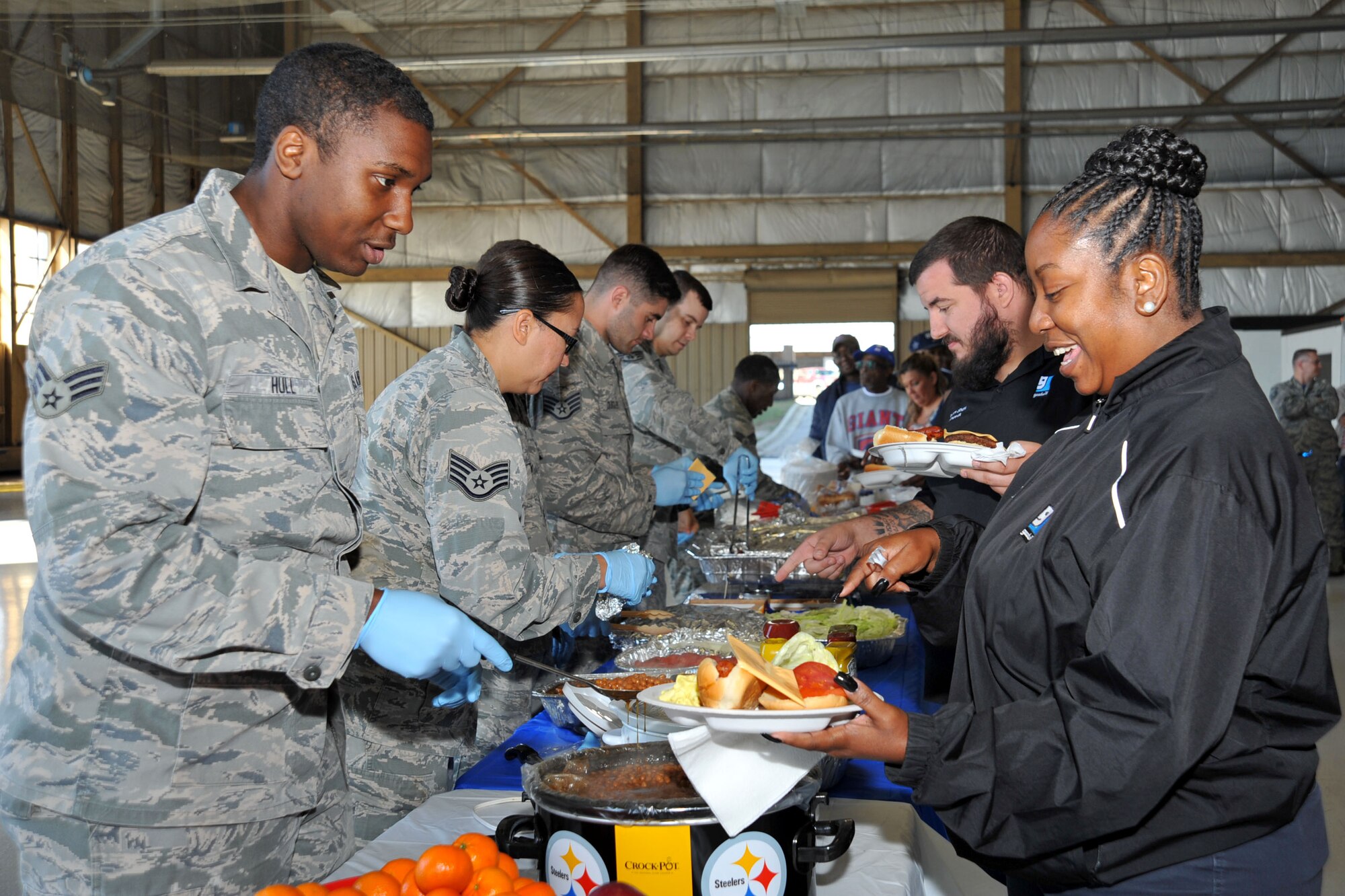 U.S. Airmen assigned to the 20th Fighter Wing serve food to attendees at the 18th Annual AbilityOne Picnic at Shaw Air Force Base, South Carolina, Oct. 27, 2017.