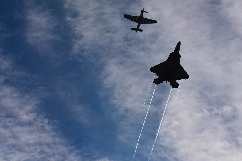 F-22 Raptor and P-51 Mustang fly side-by-side.