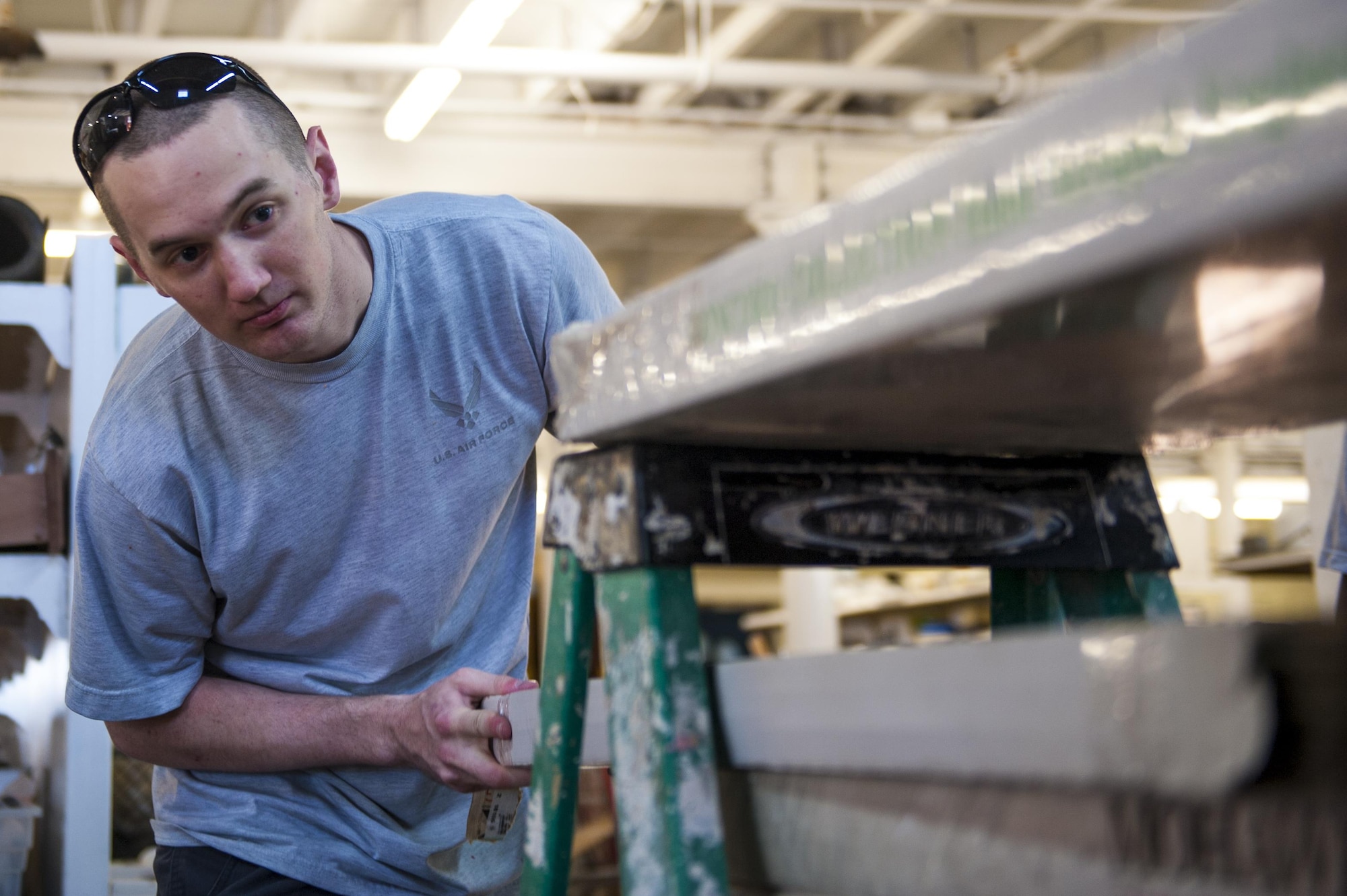 U.S. Air Force Airman 1st Class Timothy Gill, 17th Communications Squadron knowledge manager, organizes wooden planks at the Habitat for Humanity center in San Angelo, Texas, Oct. 26, 2017. Once a month, the 17th Communications Squadron pulls together and volunteers, and for October they chose Habitat for Humanity. (U.S. Air Force photo by Senior Airman Scott Jackson/Released)