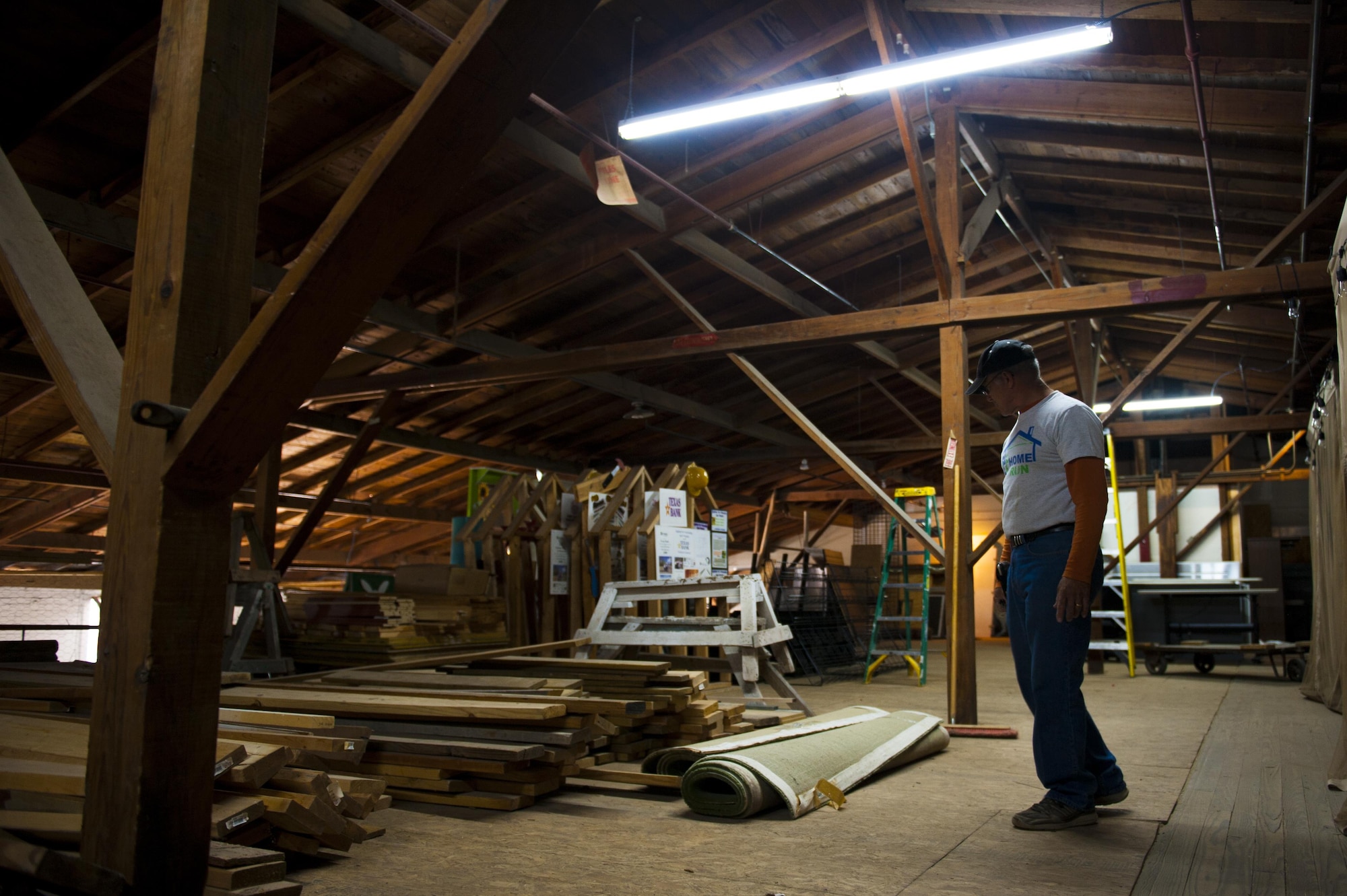 A Habitat for Humanity volunteer, surveys donated carpets and rugs at the HFH center in San Angelo, Texas, 26 Oct., 2017. The HFH center takes in donations from local businesses, and resells them and then uses the profits to buy materials for building houses. (U.S. Air Force photo by Senior Airman Scott Jackson/Released)